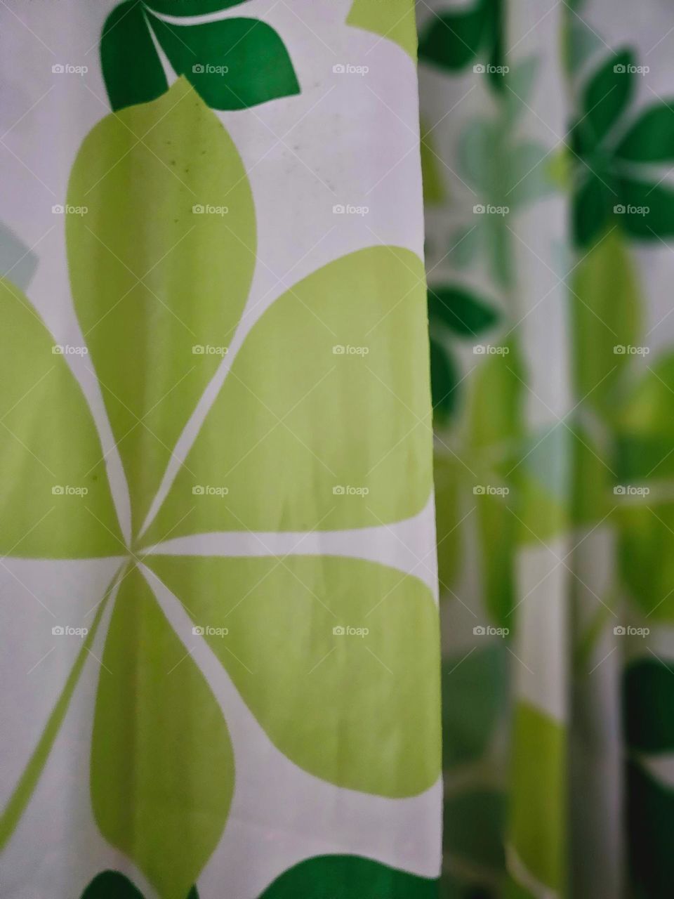 Shades of green leaves on shower curtain