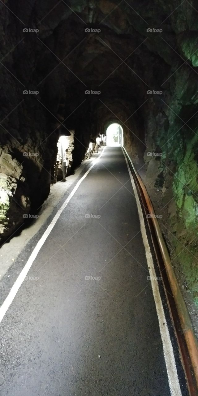 dark tunnel with light at end.
