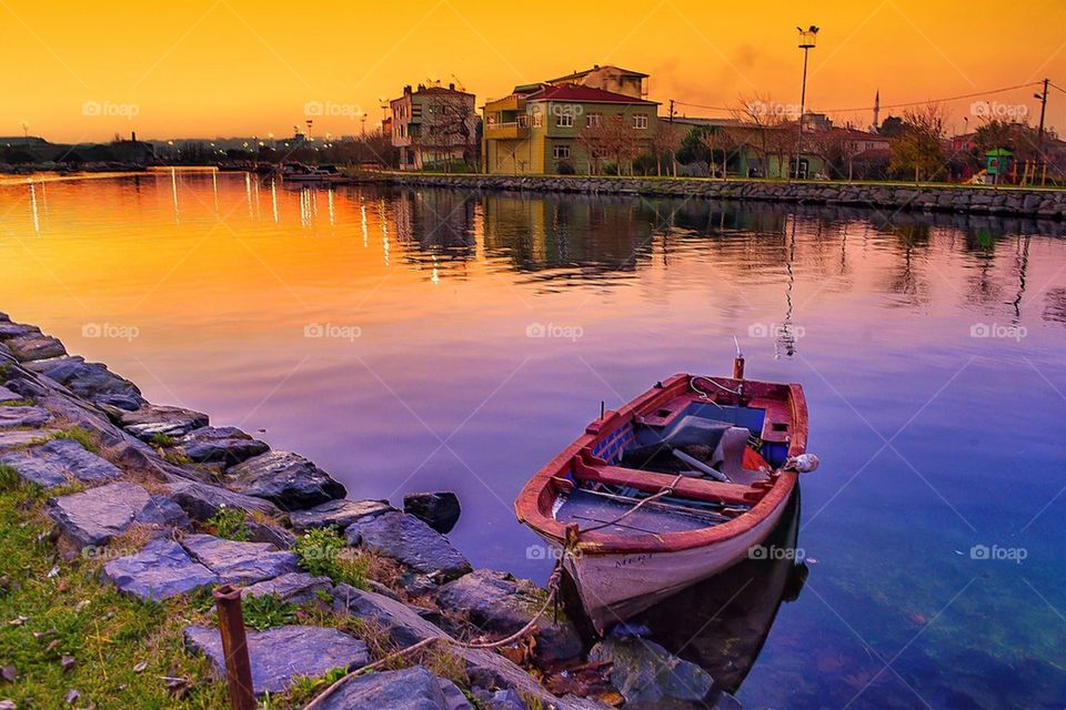 Scenic view of boat in lake during sunset