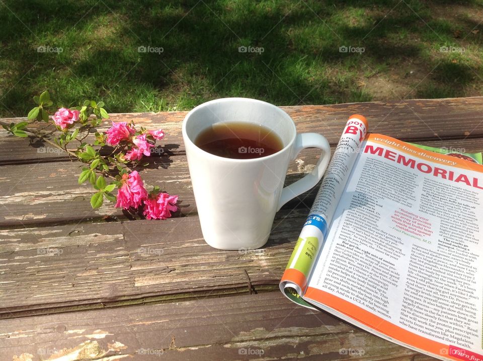 Enjoying a cup of coffee outdoors on a beautiful spring day.