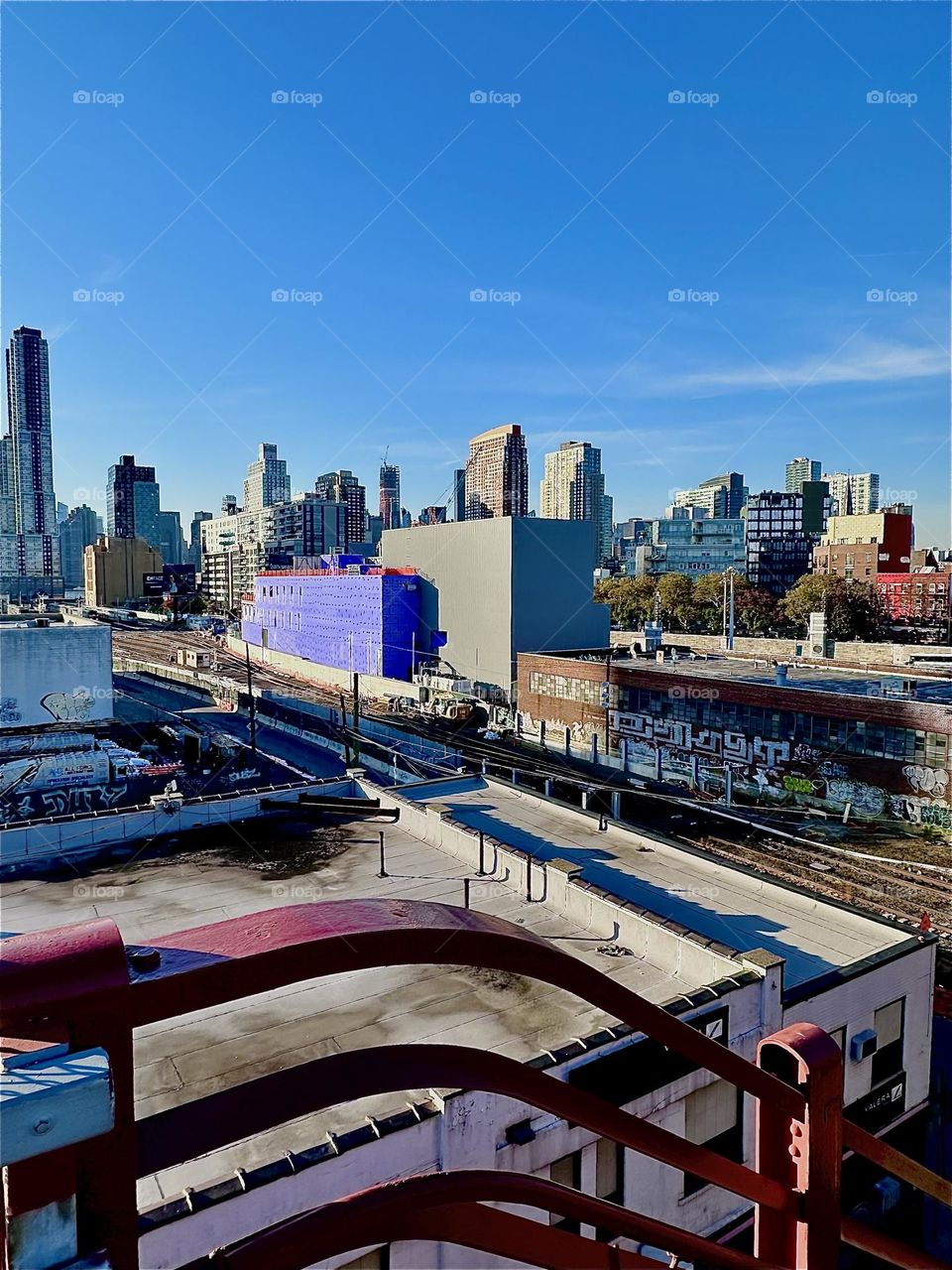 This is the tracks of the “Long Island Railroad” seen from the top of the staircase of the “Pulaski Bridge” in LIC, Queens on a warm sunny Indian summer afternoon in early November 2023. Hypnotic Productions
