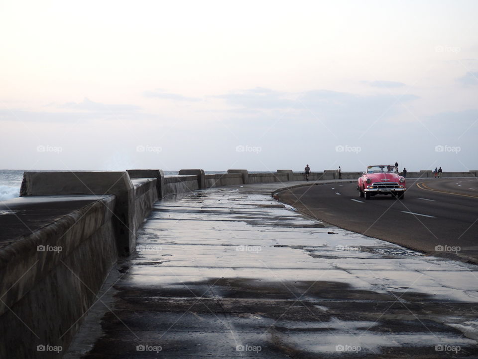 Pink oldtimer during the evening on the malecon in Havana, Cuba.