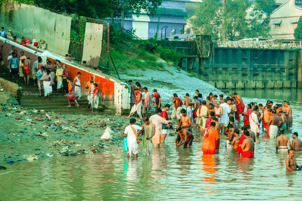 HARIDWAR, INDIA - JANUARY 14, 2016: Devotees taking holy dip at Har Ki Pauri on river Ganga on the first bath of Ardh Kumbh fair. People took a dip in holy Ganges on the occasion of Makar Sankranti