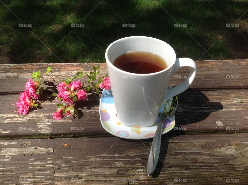 Enjoying a cup of coffee on a beautiful spring day outdoors.