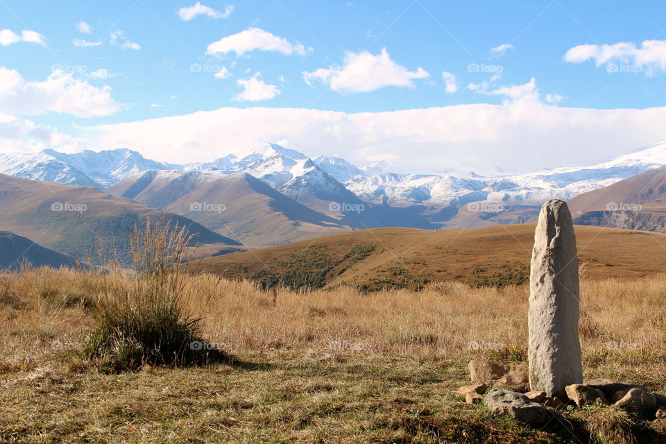 Stone sculptures against the backdrop of Elbrus.