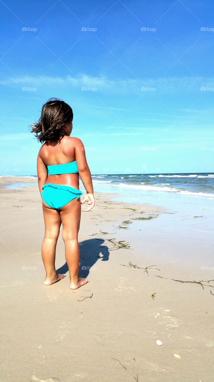 Rear view of a girl looking at sea