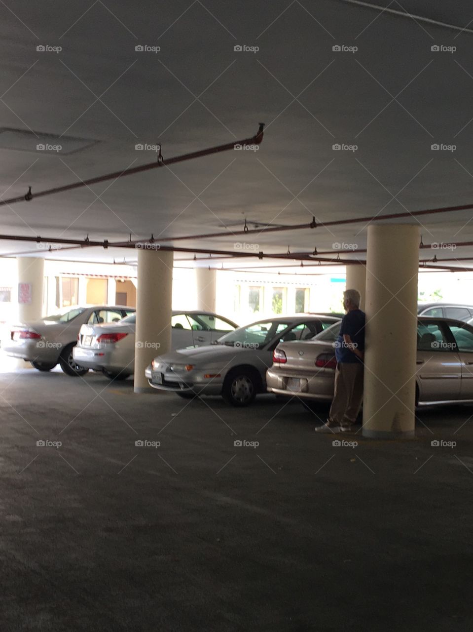 Parking lot and here's a man saving a parking spot, I hate that and I need to park my car for an appointment.