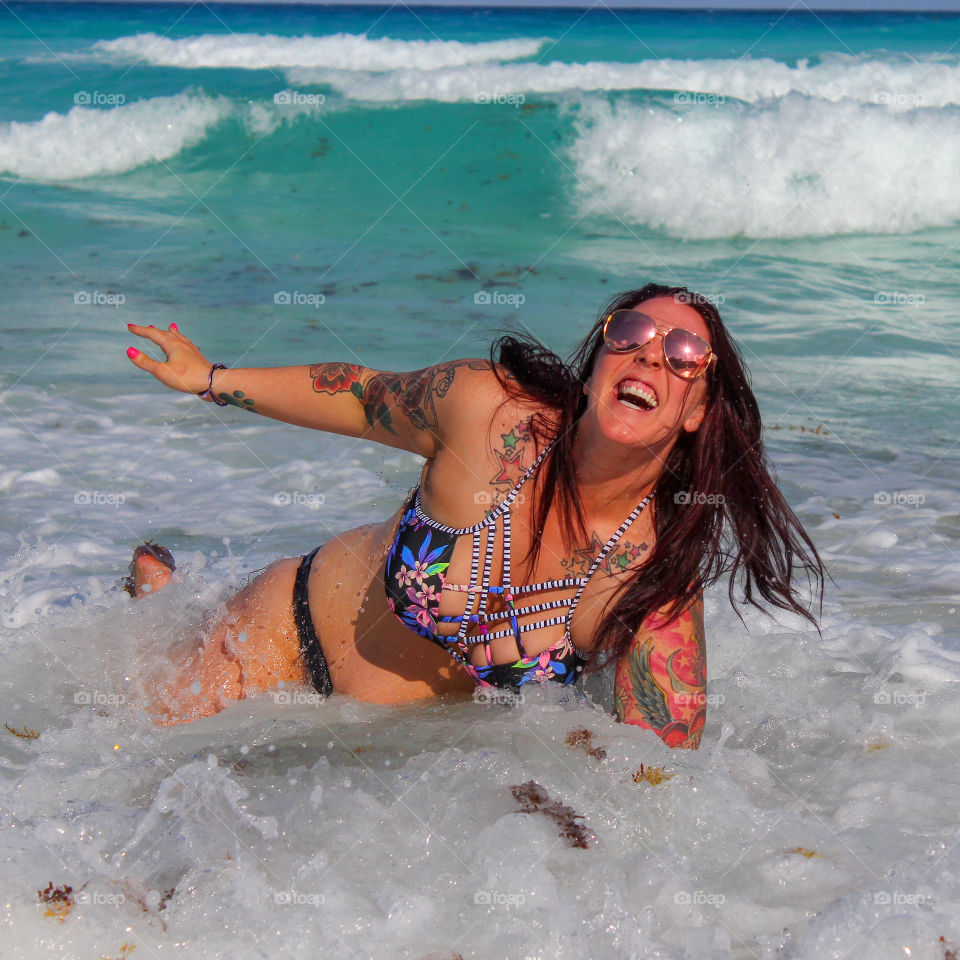 Woman enjoying the waves on a Caribbean beach