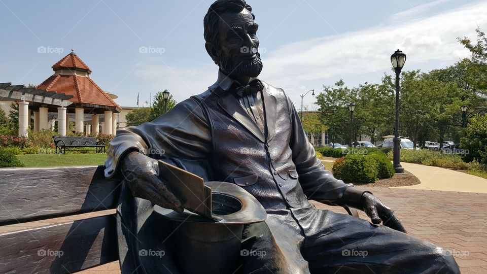 this is a permanent fixture of an Abraham Lincoln sculpture on a bronze park bench... near downtown Springfield