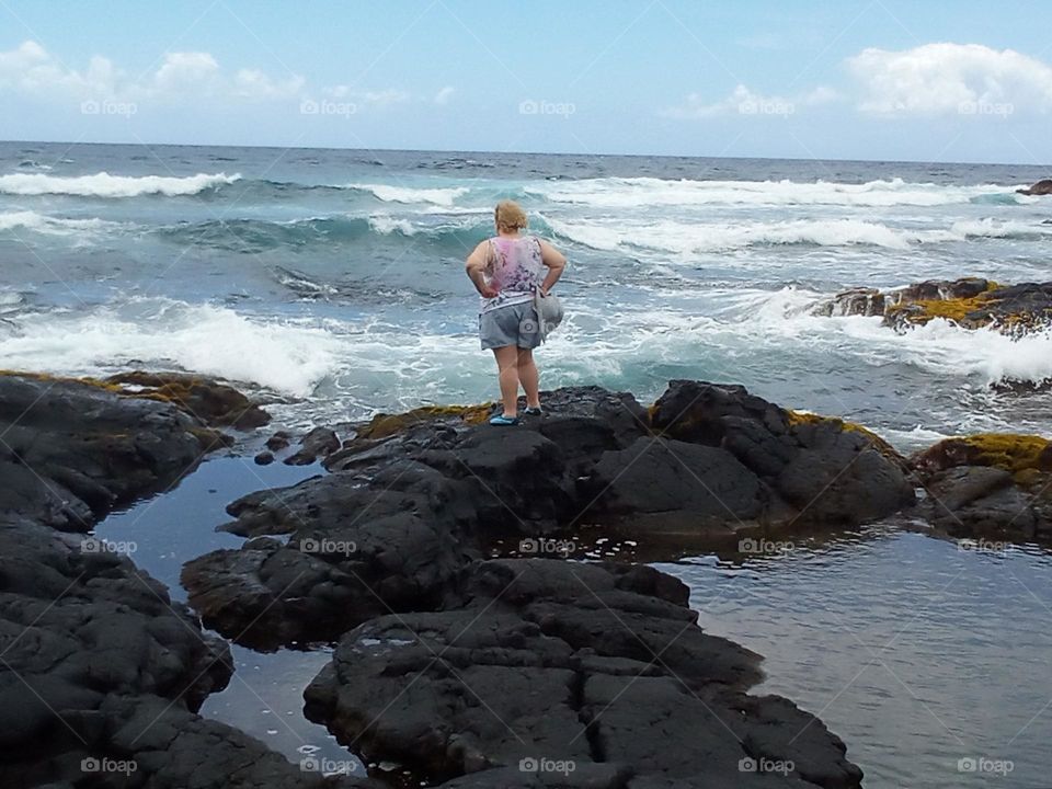 Punalu'u Black Sand Beach Kona Hawaii.  Here is where the  dark Lava rocks contrast the blue and green water topped with striking white breaking waves. The beauty and expanse of the scene is mesmerizingly captivating!