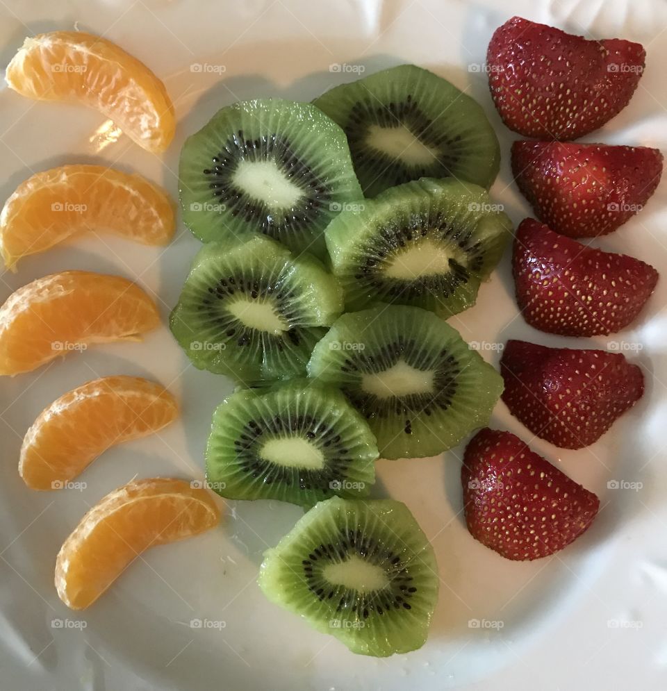 Plate of mandarins, kiwi, and strawberries