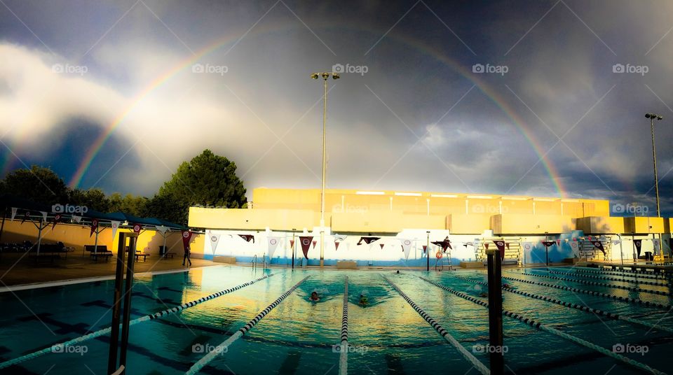 A bery filtered rainbow over the pool.