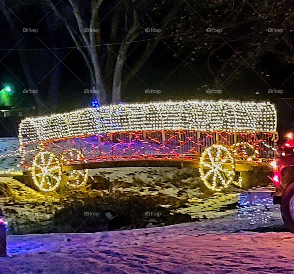 Christmas light covered wagon