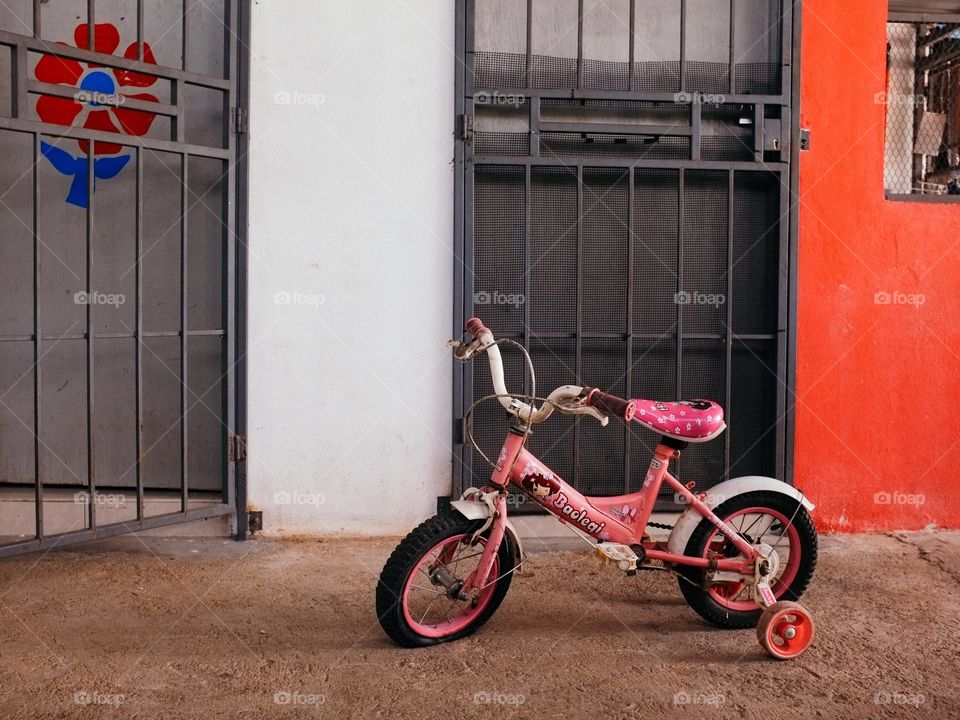 A children bicycle parked in front of a house