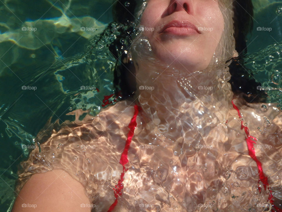 woman swimming. woman in red swimwear swimming in the sea