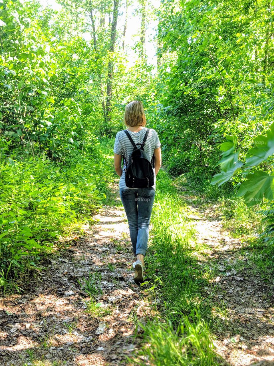 A girl walking through the woods