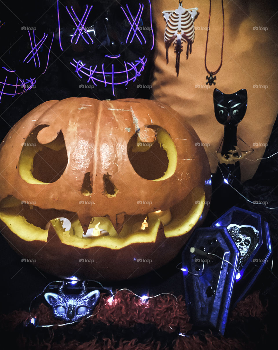 A carved pumpkin, black cat, led masks and some Halloween themed resin items that I made