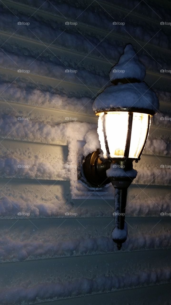 Snow covered lantern porch light