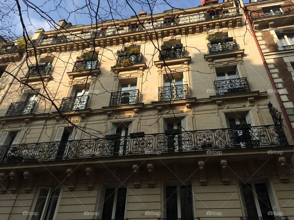 Beautiful old building in Paris in the winter sun. Building facade. Building history. French building. City building. 