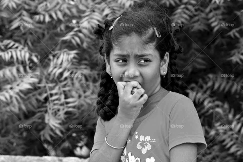 Joyful moment of biting a raw fruit by a girl.