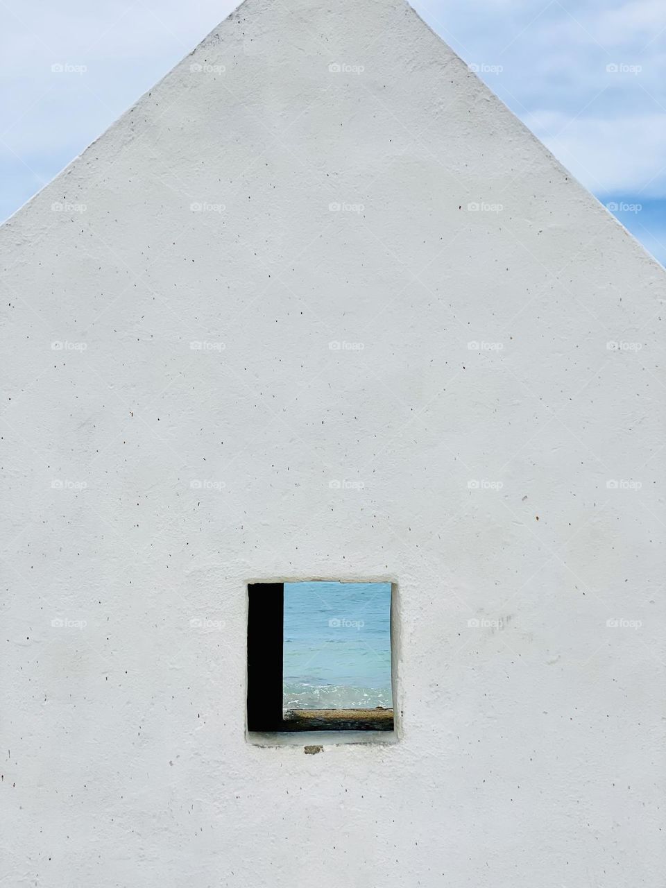 Looking through the window of a former slave hut