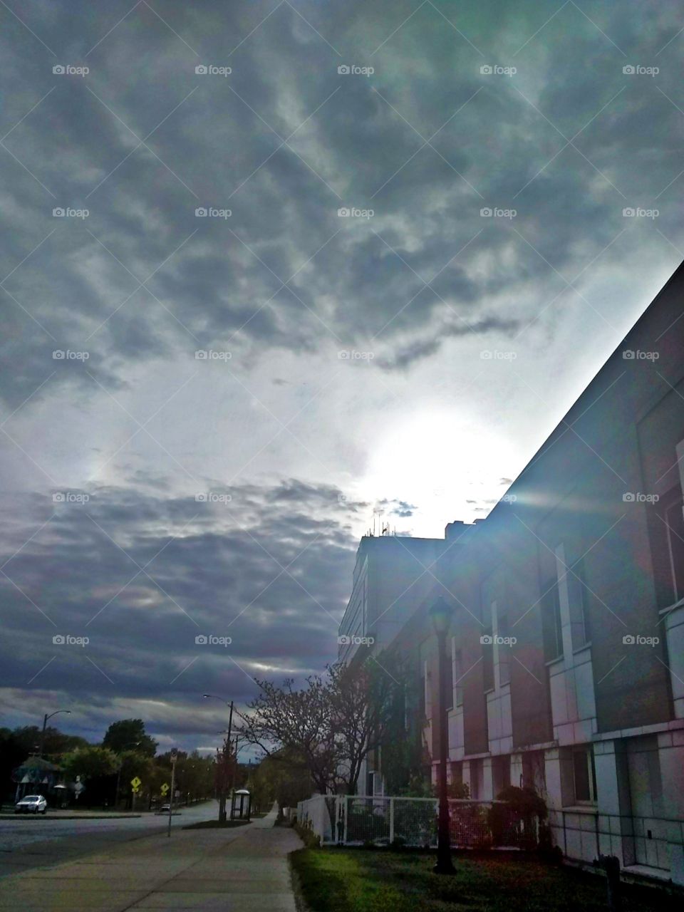 The sun shines through the clouded day while taking a break outside of the hospital.  Photographer: Lee La Beez of Beez Lee Art.