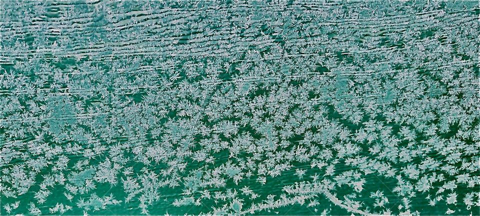 The icicles that cover the surface of. a wooden door look like a large meadow covered with daisies in bloom at first glance. 2023. Hypnotic Productions