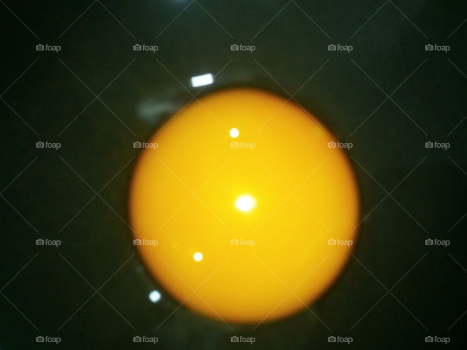 One yellow egg/egg yolk in a black pan