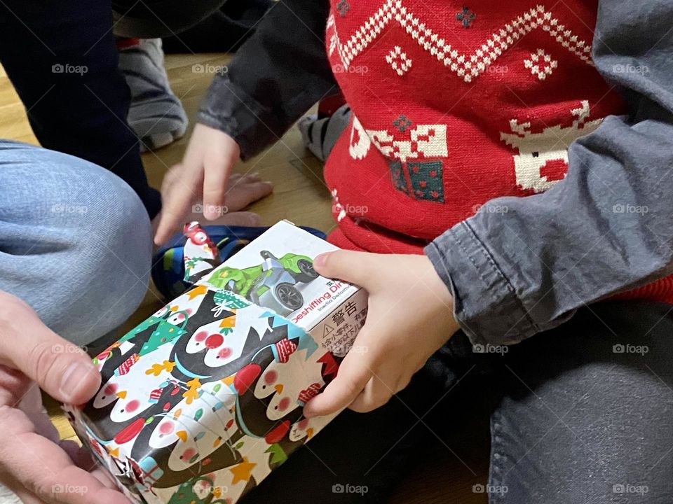 Little boy unpacking gifts 