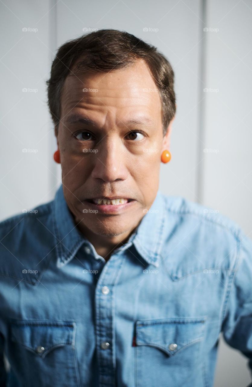 Silly cross eyed man with orange earrings 