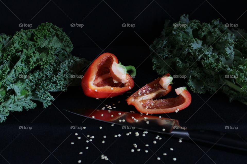 Sliced Red Bell Pepper, Seeds, Leafy Lettuces and Knife