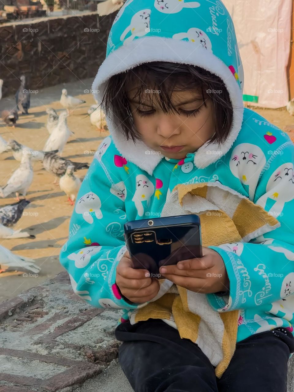 Cute little girl playing with technology