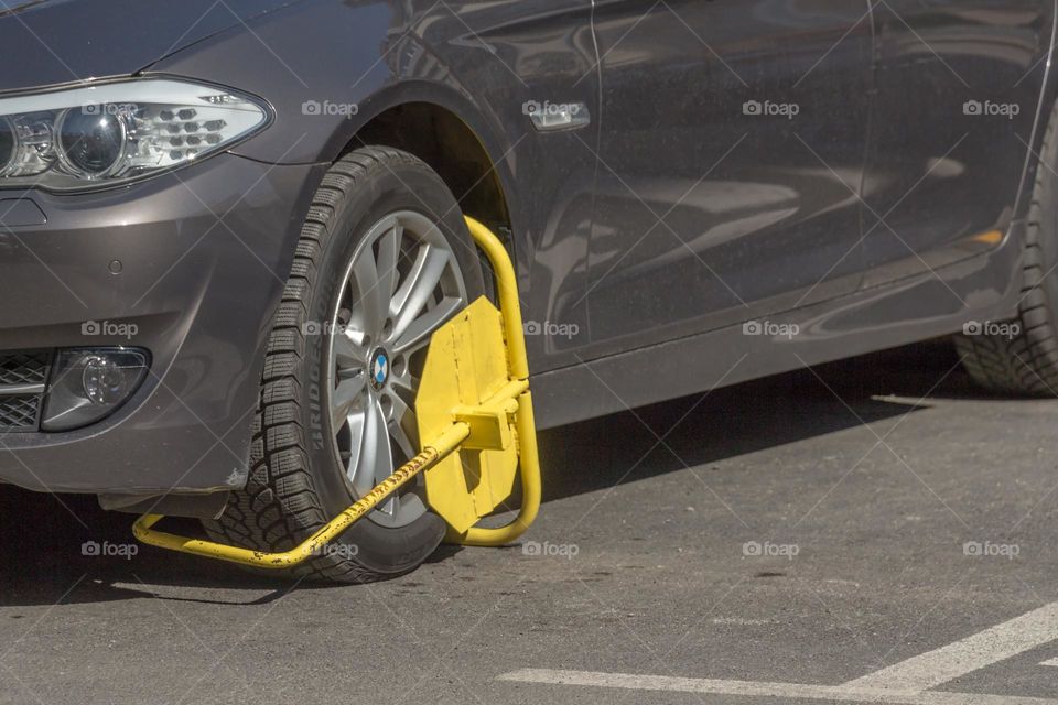 Improperly parked car with a wheel clamp