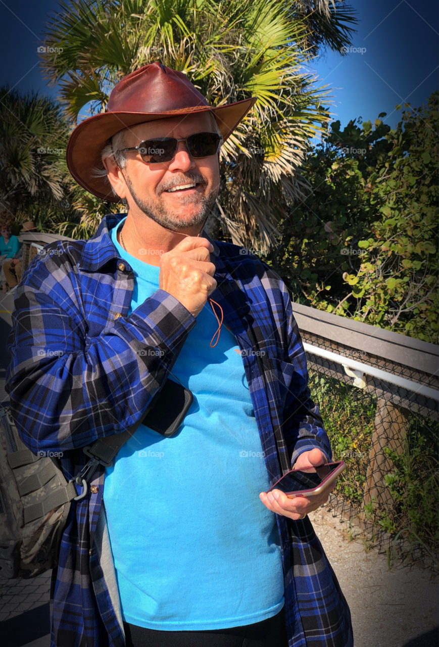 Happy smiling man hiking.