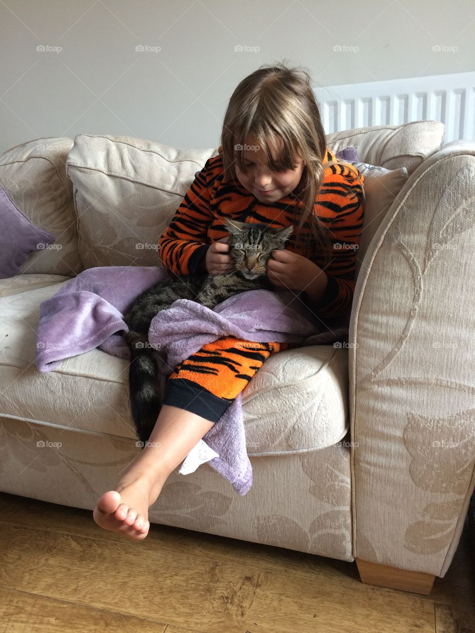 Girl sitting on sofa with cat