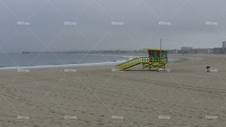 Colorful lifeguard post on the sand headed toward the Venice Beach Pier