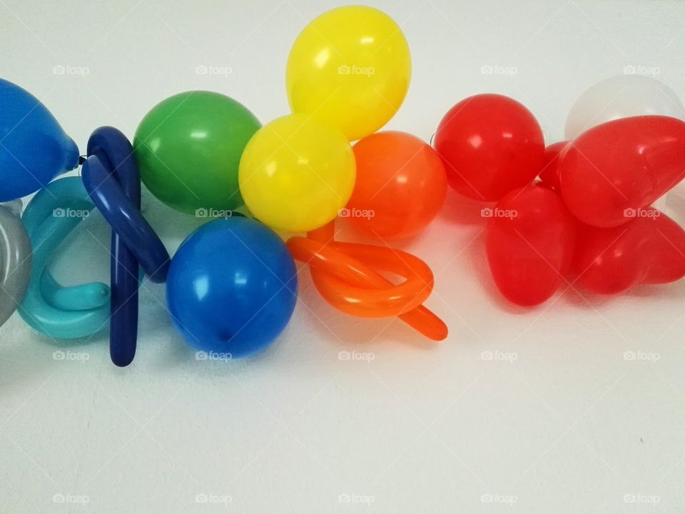 colorful balloons hanging on white wall