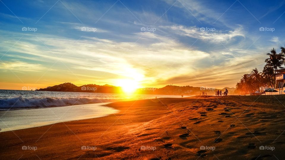 Surf at beach at the time of sunset