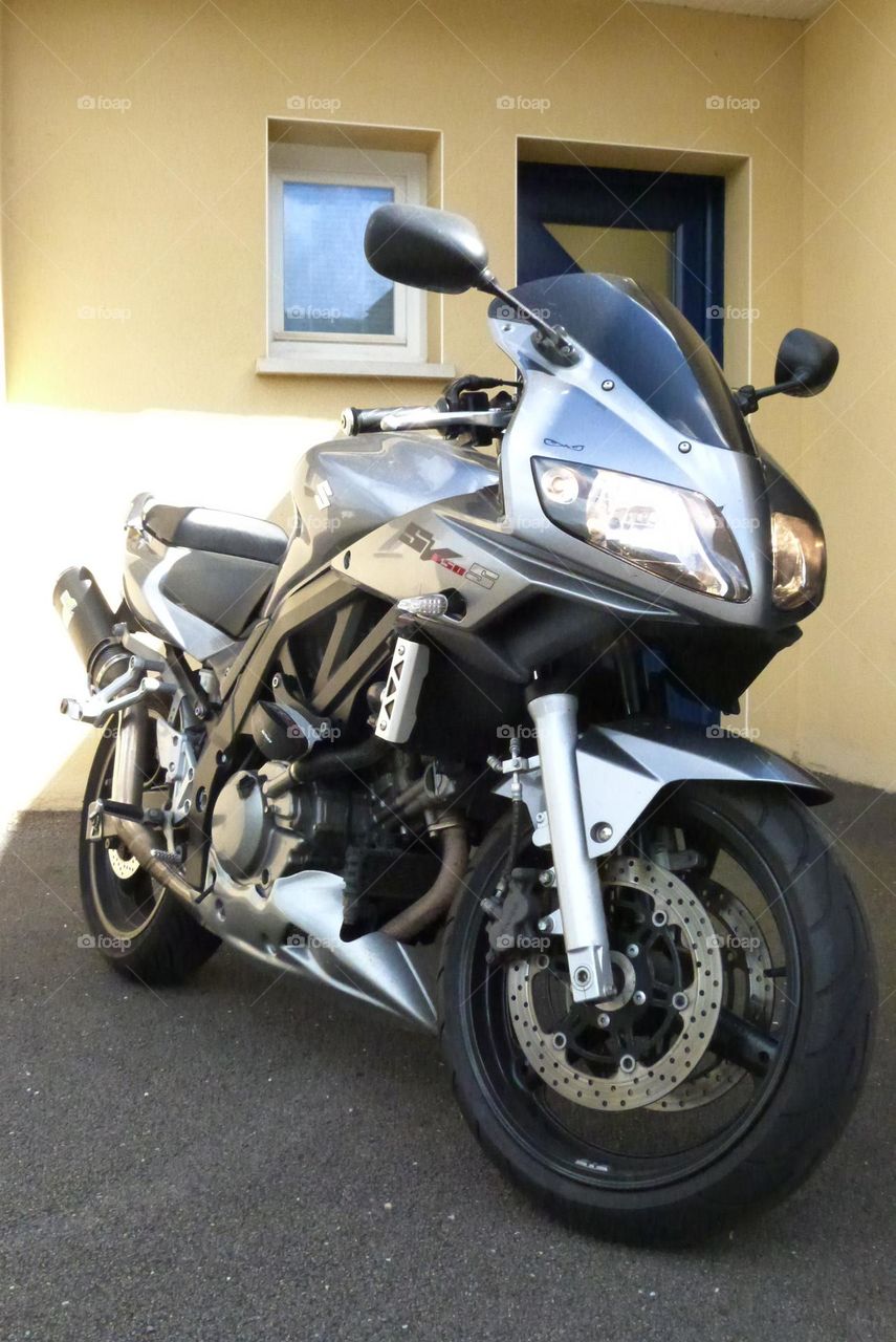 A motorbike ready to leave its owner's home for a daily commute.