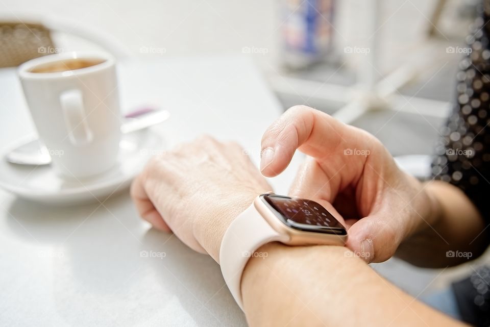 Looking at the smart watch during a coffee break 