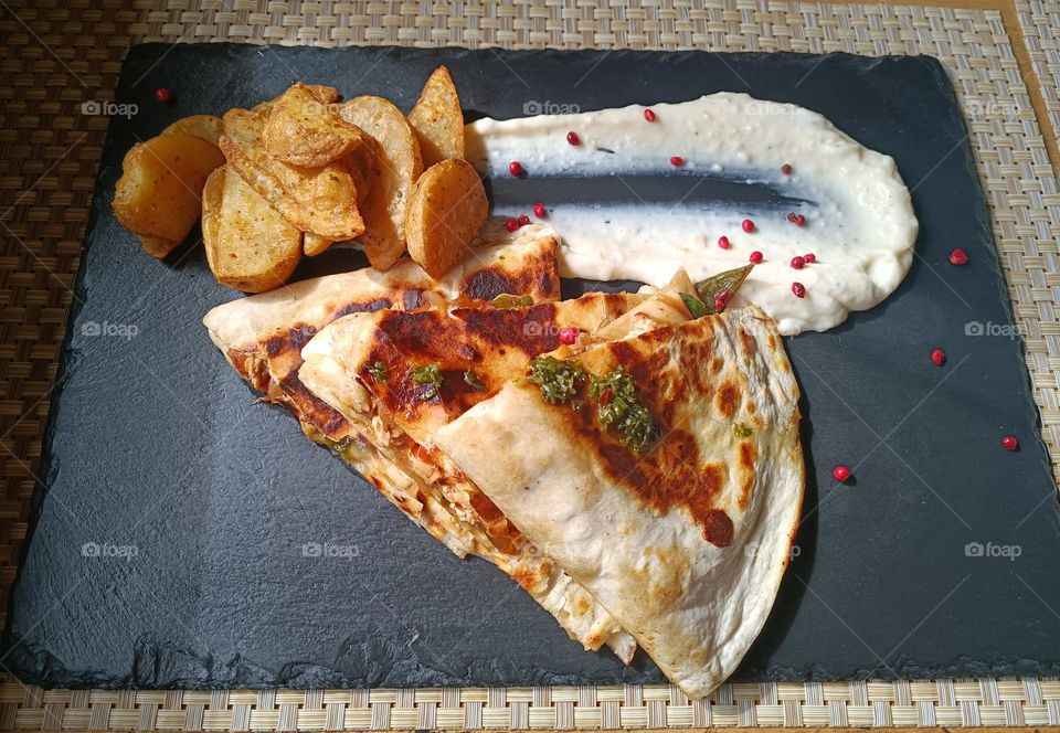 Taste some delicious quesadillas with potatoes.