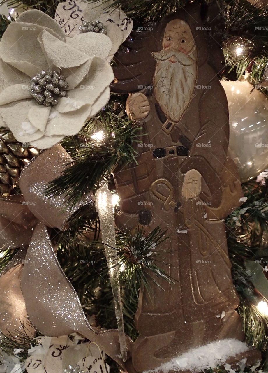 Father Christmas ornament on a well decorated tree. 