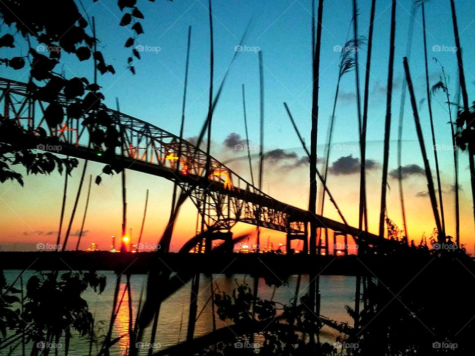 Beautiful shot of a bridge at sunset near the Gulf Coast of Texas on the Gulf of Mexico and the Sabine River. United States of America 2018 May