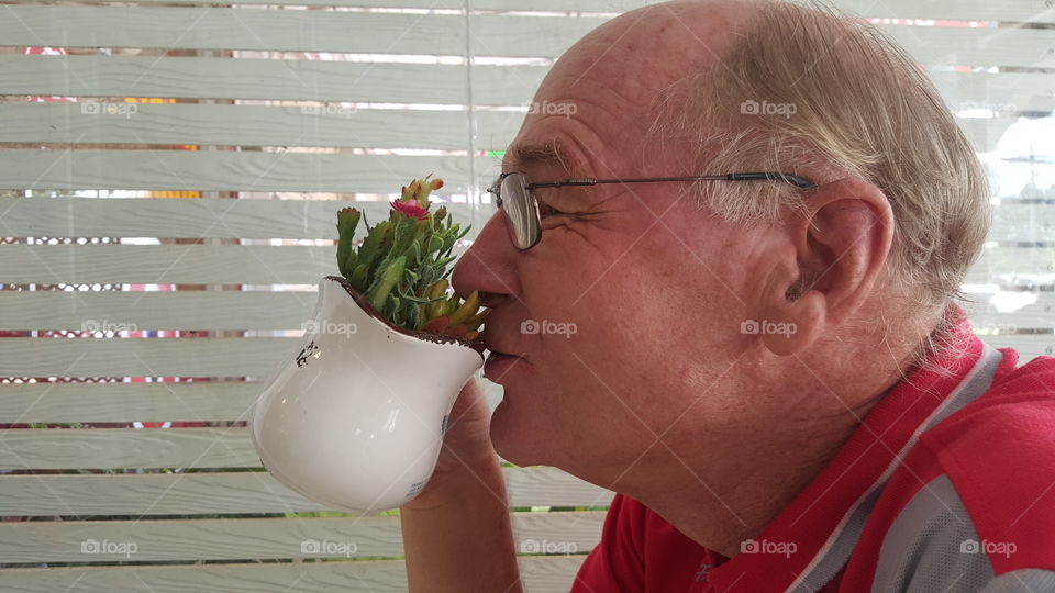 immersive nature. An old man model  immersive the herbs in coffee cup with happy ,  abstract impression scene