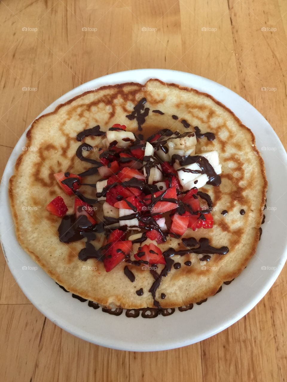 Pancake with banana and strawberries 