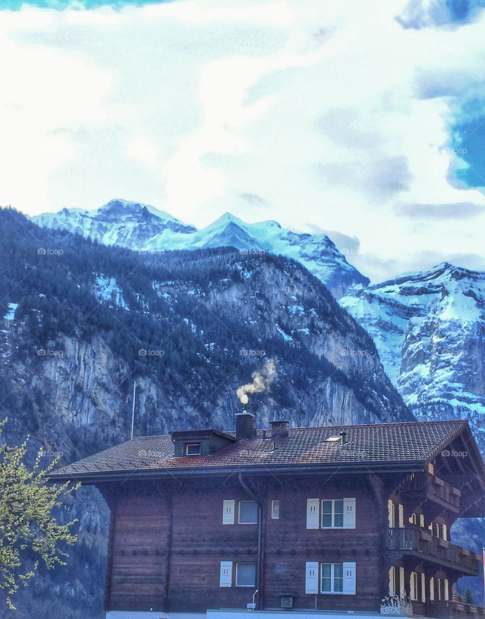 Swiss cottage below the mountains 