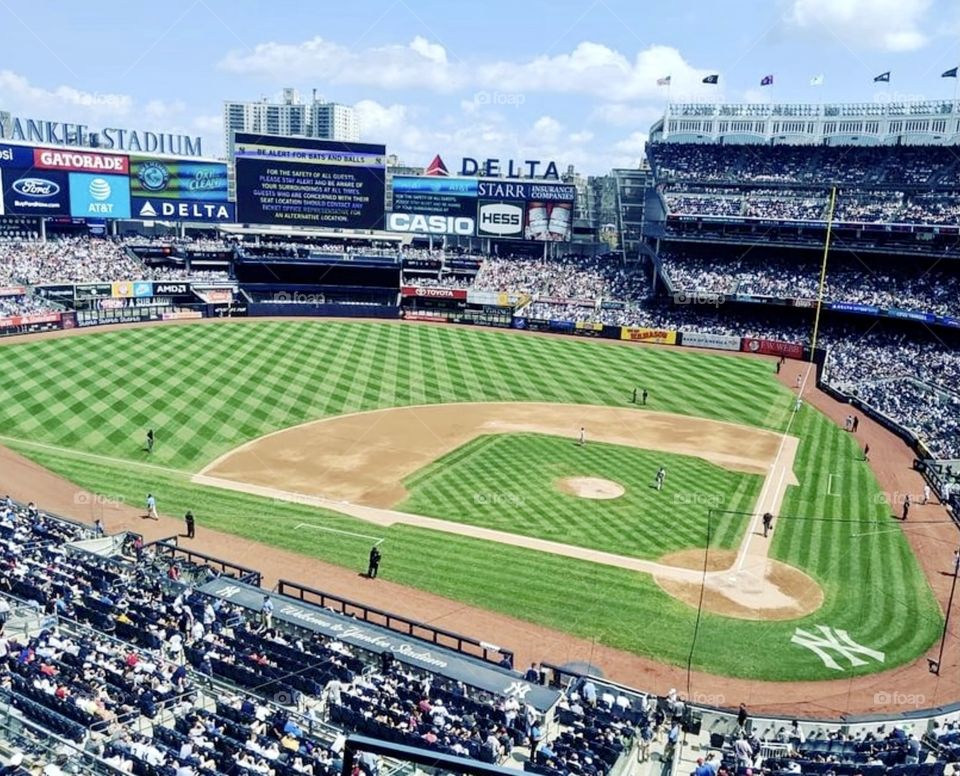 Waiting in our seats at Yankee Stadium looking down at the freshly groomed field before the players enter for the game 