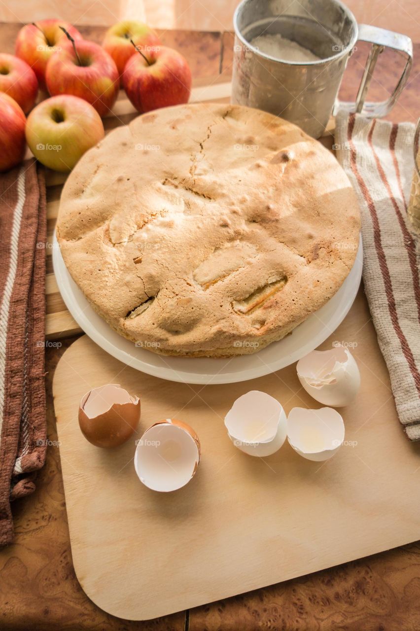 Making homemade puffed apple pie with eggs, sugar and flour.