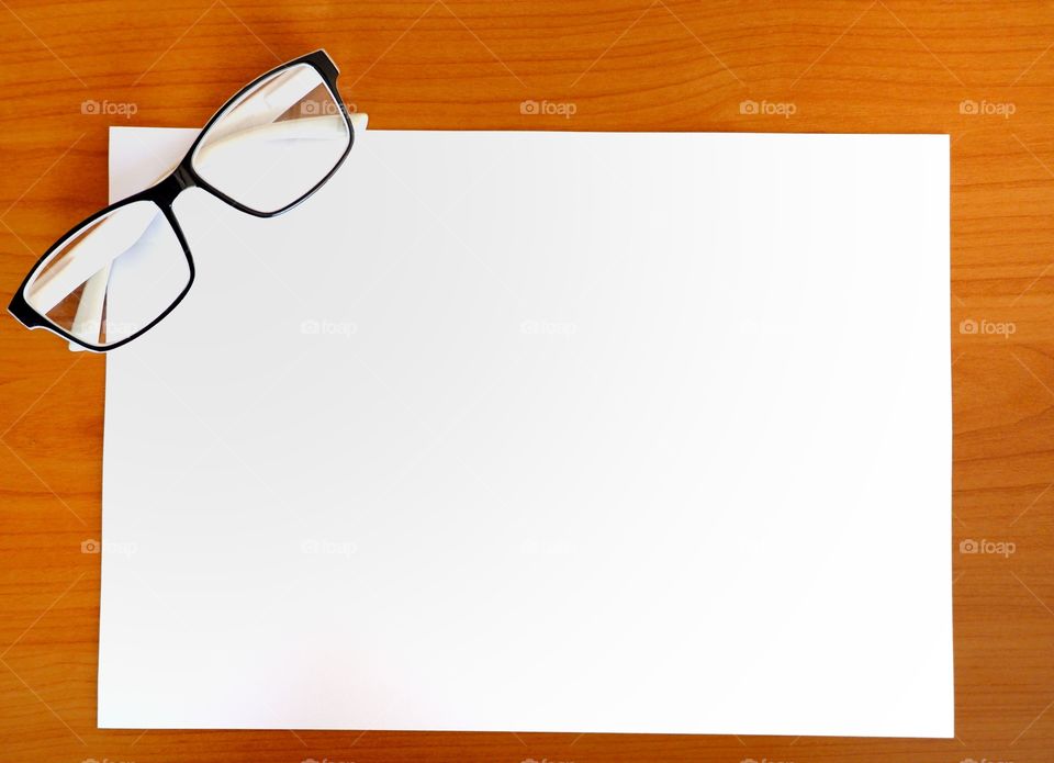 Blank paper with glasses for your text.