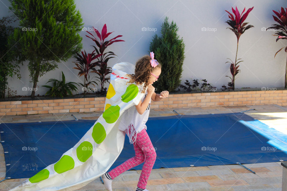 My little girl enjoying her imagination in the backyard